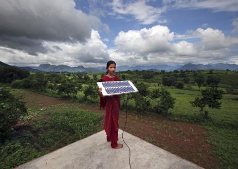 Girl stands with solar panel